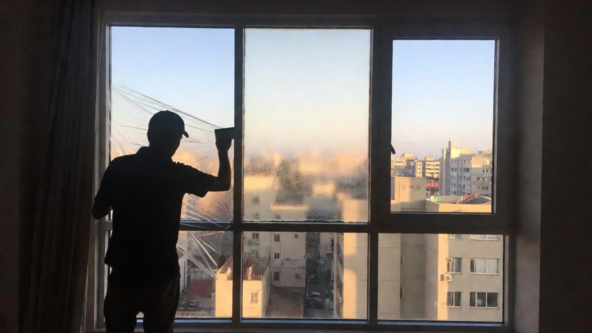 person-installing-window-film-image