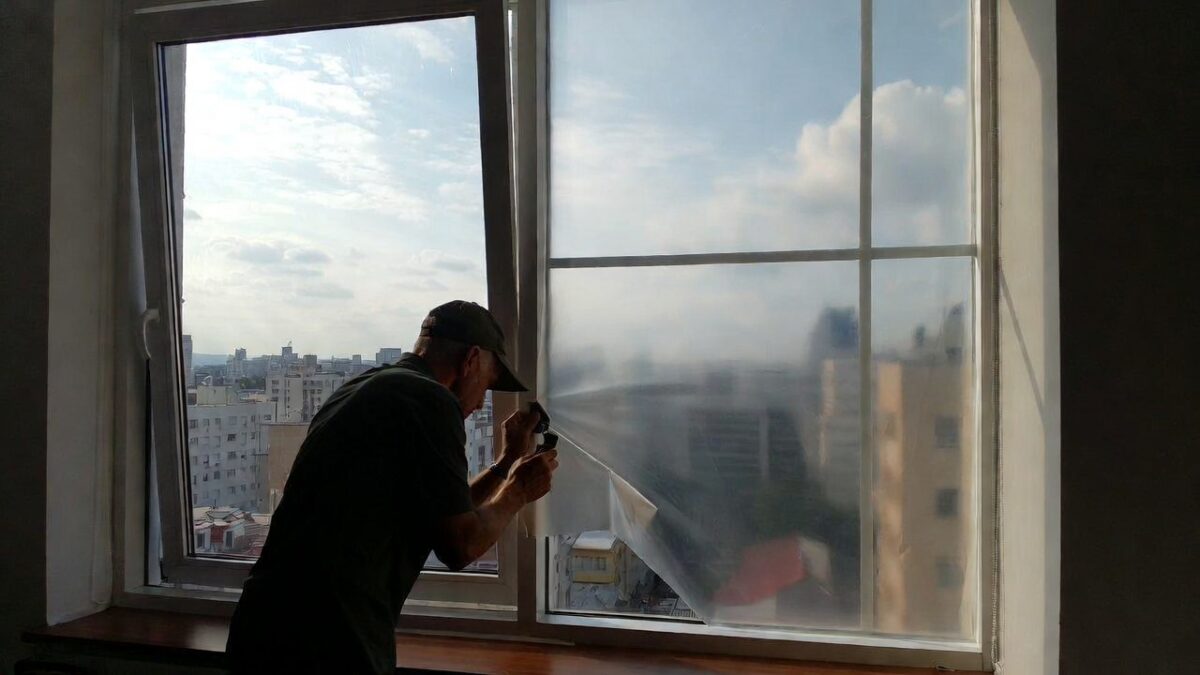 person removing window film image